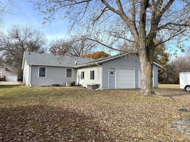 rear view of property featuring a garage