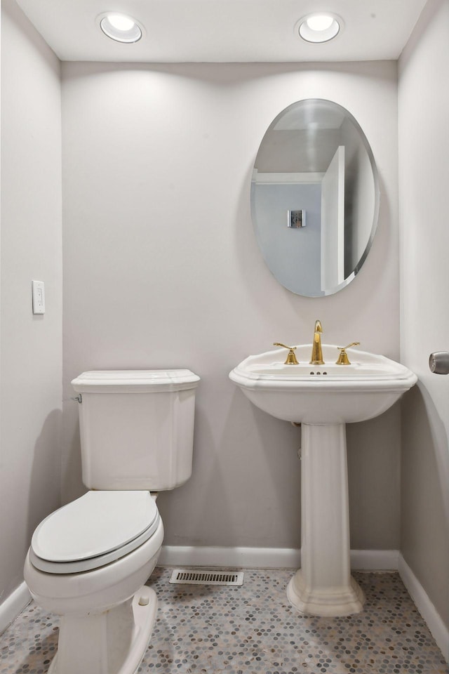 bathroom featuring toilet, sink, and tile patterned floors