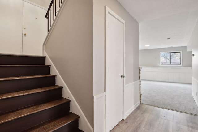 stairs featuring wood-type flooring