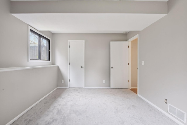 unfurnished bedroom featuring light colored carpet