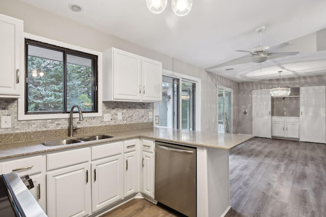 kitchen with stainless steel dishwasher, white cabinets, sink, and kitchen peninsula