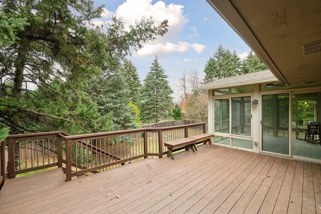 wooden deck with a sunroom