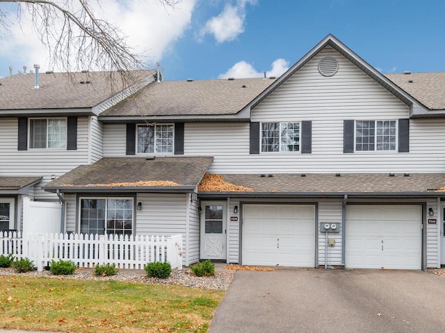 view of front of property with a front yard and a garage