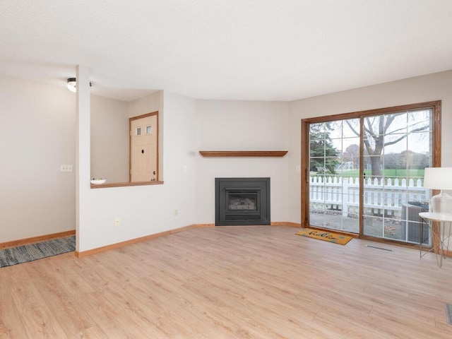 unfurnished living room with light wood-type flooring