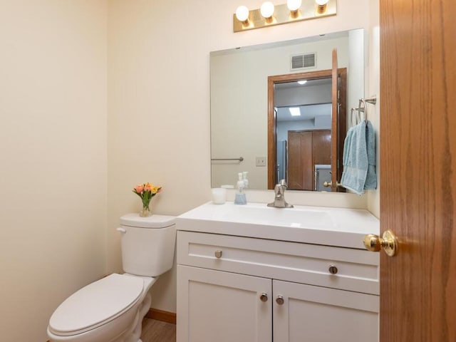 bathroom with toilet and vanity