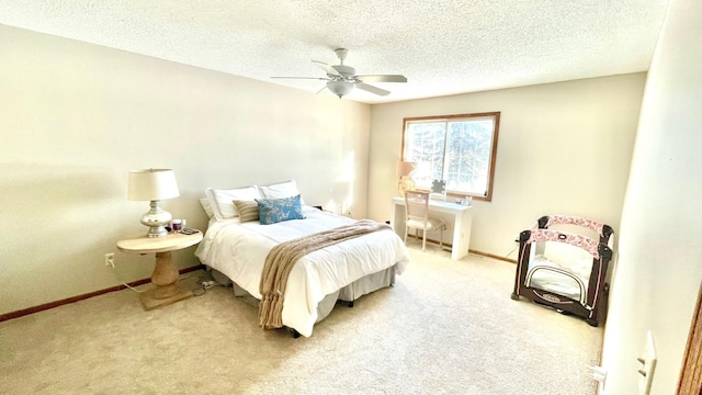 bedroom with a textured ceiling, ceiling fan, and carpet flooring