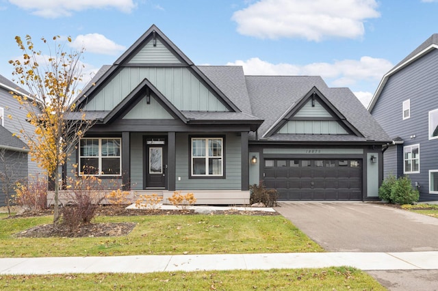 craftsman house with a garage and a front yard