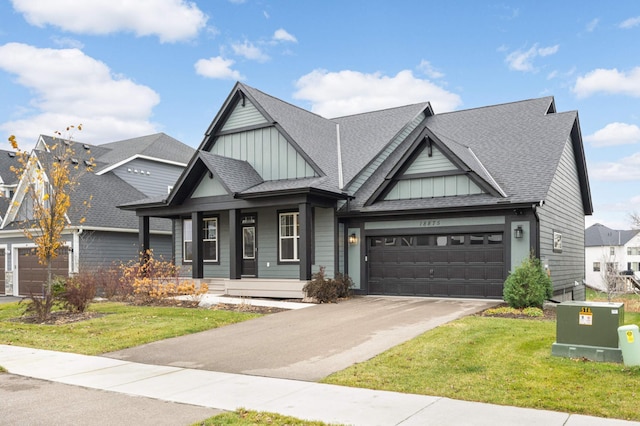 craftsman inspired home with a garage, covered porch, and a front lawn