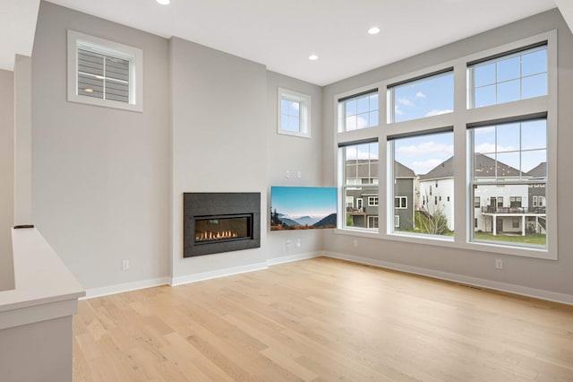 unfurnished living room with light hardwood / wood-style flooring