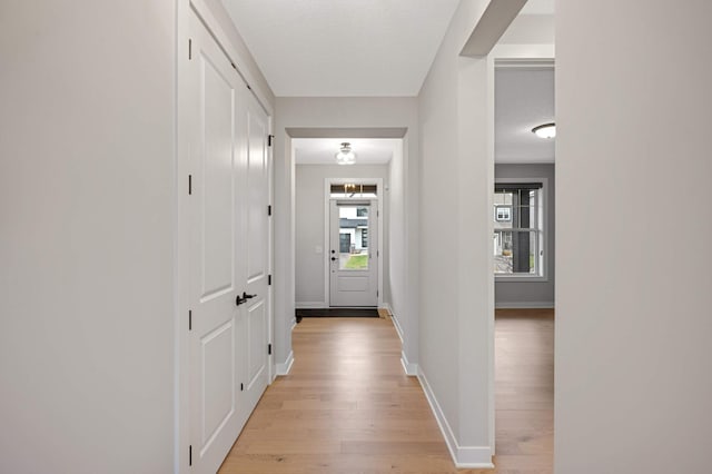 corridor with light hardwood / wood-style flooring