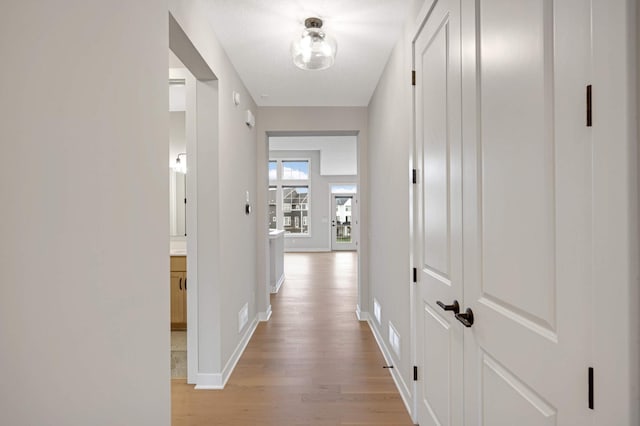 hall with light wood-type flooring