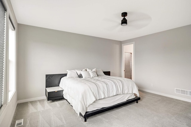 bedroom with ceiling fan and light carpet