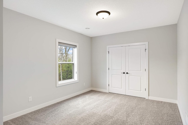 unfurnished bedroom with a closet and carpet