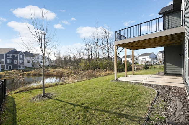 view of yard with a deck with water view and a patio area