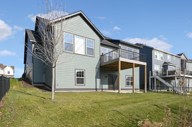 rear view of property featuring a patio and a lawn