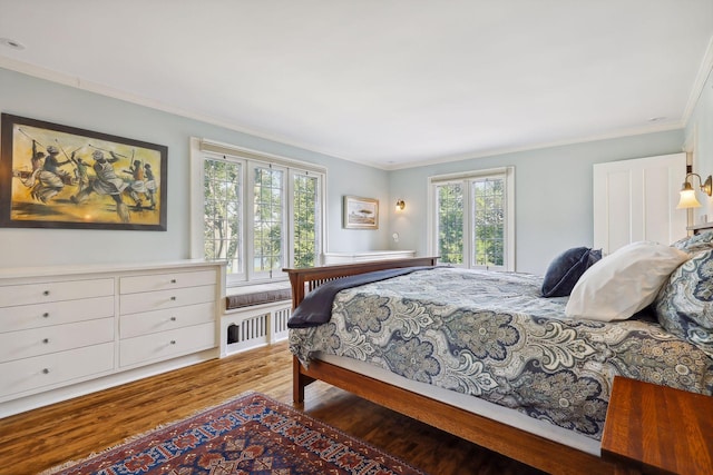 bedroom featuring crown molding and hardwood / wood-style floors