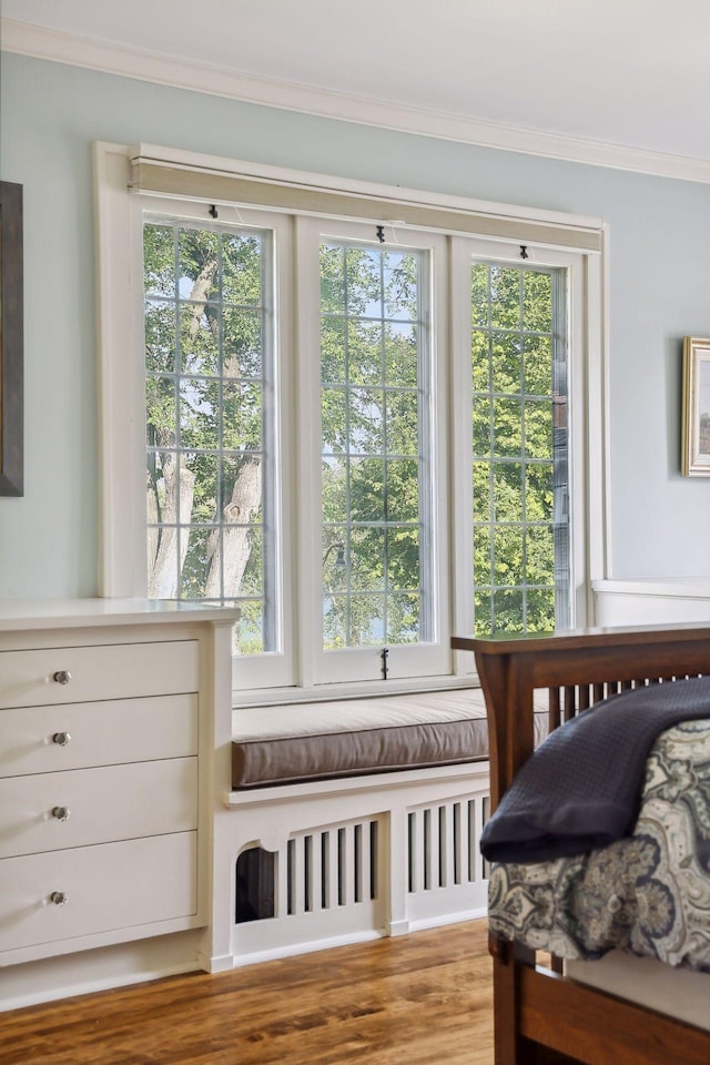 bedroom with light wood-type flooring and multiple windows