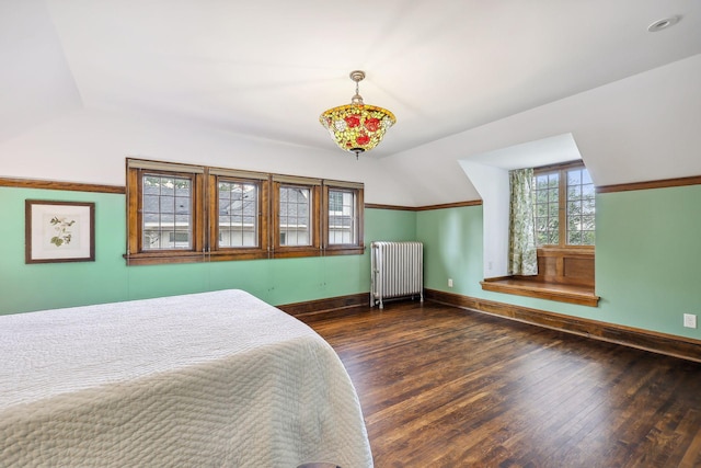 bedroom featuring radiator heating unit, vaulted ceiling, and dark wood-type flooring