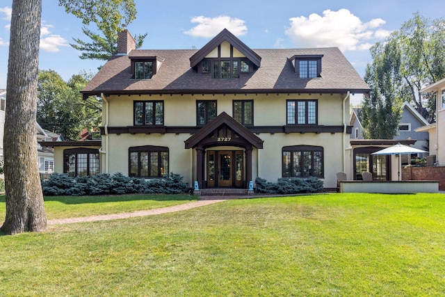 view of front of house with french doors and a front yard