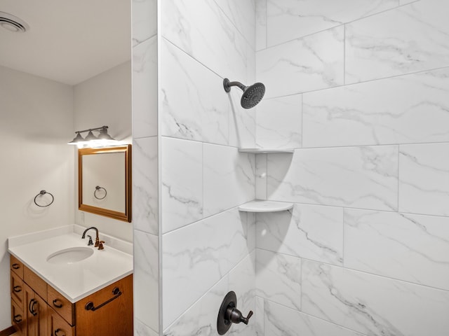 bathroom featuring vanity and a tile shower