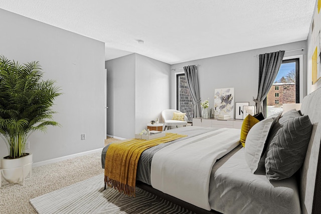 bedroom featuring carpet floors and a textured ceiling