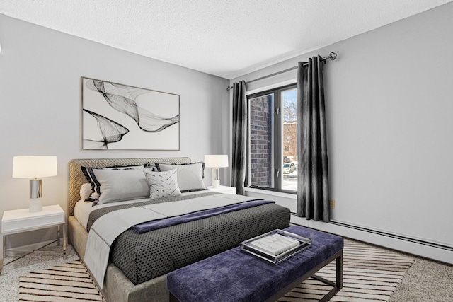 bedroom with a textured ceiling and a baseboard radiator