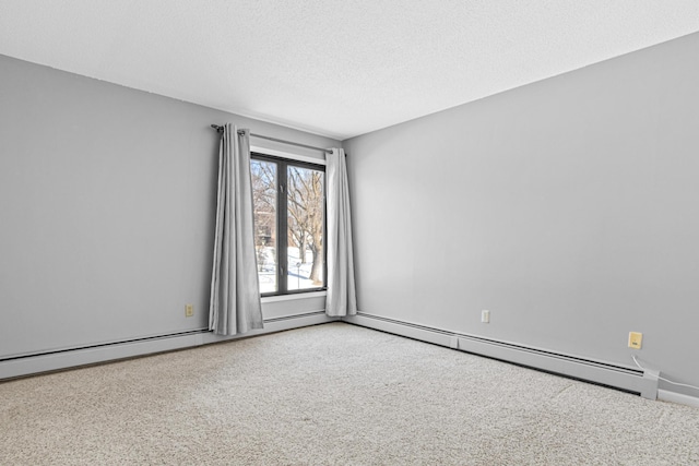 carpeted empty room with baseboard heating and a textured ceiling