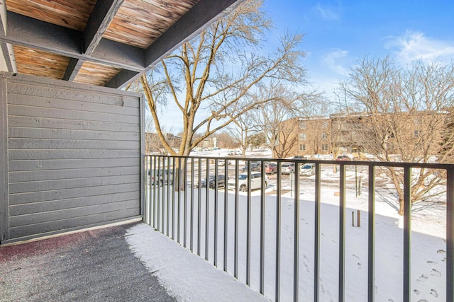 view of snow covered back of property