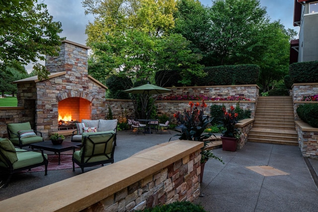 19752 Halwood Rd, Glenwood Twp, MN 56334 - view of patio with stairway and an outdoor living space with a fireplace