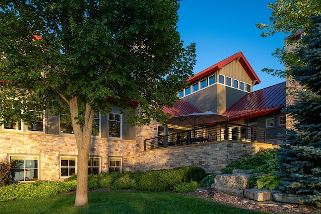 19752 Halwood Rd, Glenwood Twp, MN 56334 - back of house with a standing seam roof, a balcony, stone siding, and metal roof