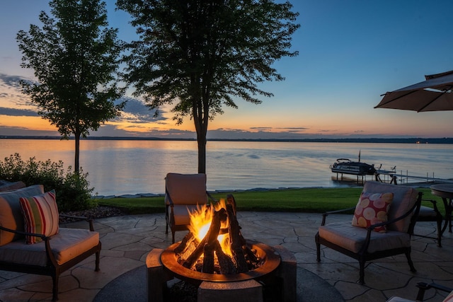 19752 Halwood Rd, Glenwood Twp, MN 56334 - view of patio / terrace featuring a fire pit and a water view