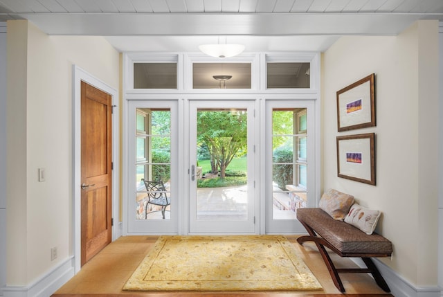 19752 Halwood Rd, Glenwood Twp, MN 56334 - entryway featuring baseboards and wood ceiling with exposed beams