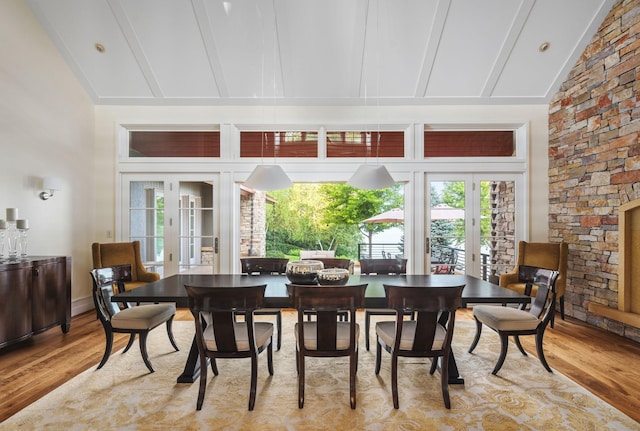 19752 Halwood Rd, Glenwood Twp, MN 56334 - dining space with french doors, light wood-style floors, high vaulted ceiling, beamed ceiling, and healthy amount of natural light