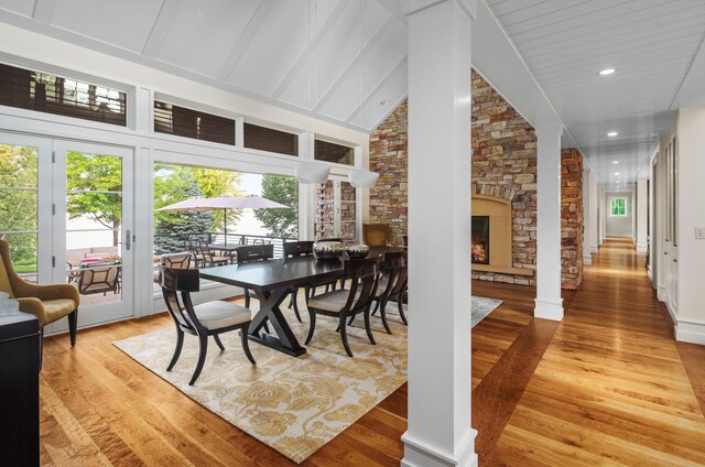 19752 Halwood Rd, Glenwood Twp, MN 56334 - dining room featuring decorative columns, light wood-style flooring, recessed lighting, and lofted ceiling