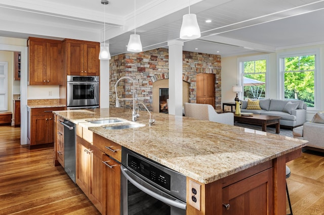 19752 Halwood Rd, Glenwood Twp, MN 56334 - kitchen featuring stainless steel appliances, open floor plan, light wood-style floors, beamed ceiling, and a sink