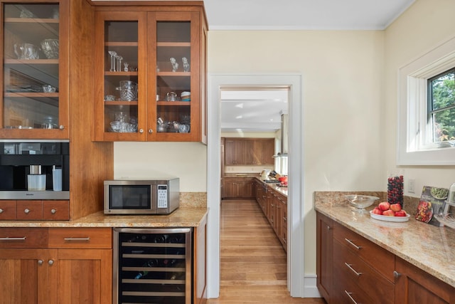 19752 Halwood Rd, Glenwood Twp, MN 56334 - bar with wine cooler, stainless steel microwave, light wood finished floors, and crown molding