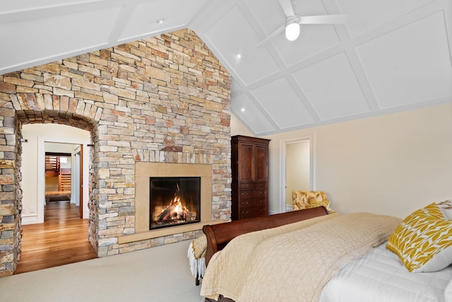 19752 Halwood Rd, Glenwood Twp, MN 56334 - bedroom featuring beam ceiling, a stone fireplace, high vaulted ceiling, arched walkways, and wood finished floors