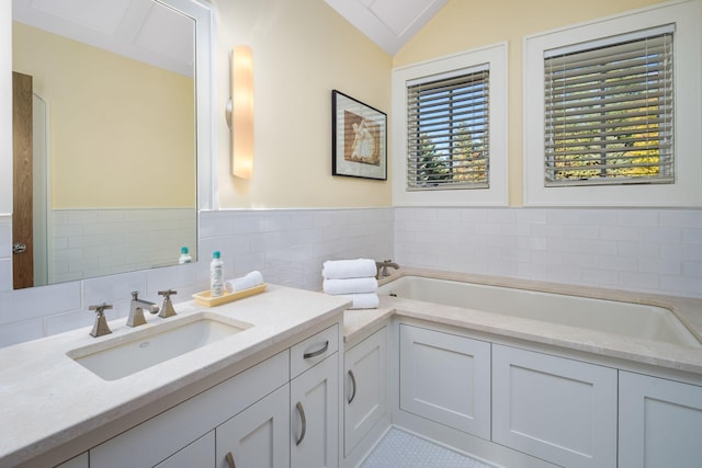 19752 Halwood Rd, Glenwood Twp, MN 56334 - bathroom featuring vanity, a bath, vaulted ceiling, and a wainscoted wall