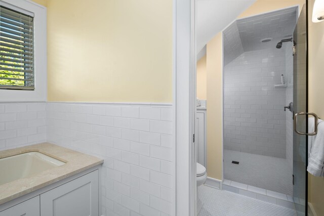 19752 Halwood Rd, Glenwood Twp, MN 56334 - full bath featuring a shower stall, toilet, tile walls, vanity, and wainscoting