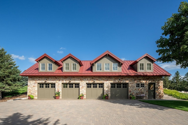19752 Halwood Rd, Glenwood Twp, MN 56334 - view of front of property with stone siding, a standing seam roof, decorative driveway, metal roof, and a garage