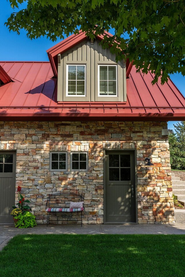 19752 Halwood Rd, Glenwood Twp, MN 56334 - view of front of house with a standing seam roof, stone siding, metal roof, board and batten siding, and a front lawn