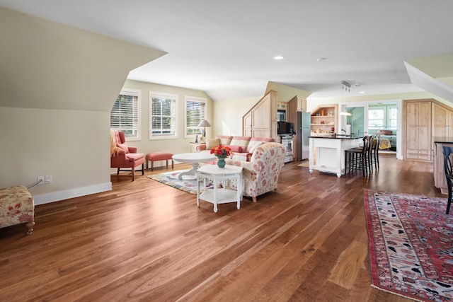 19752 Halwood Rd, Glenwood Twp, MN 56334 - living room featuring dark wood-style floors, lofted ceiling, baseboards, and recessed lighting