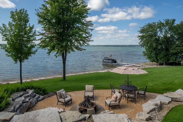 19752 Halwood Rd, Glenwood Twp, MN 56334 - view of patio / terrace with a fire pit and a water view