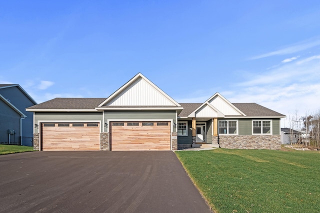 craftsman-style house featuring a front yard and a garage