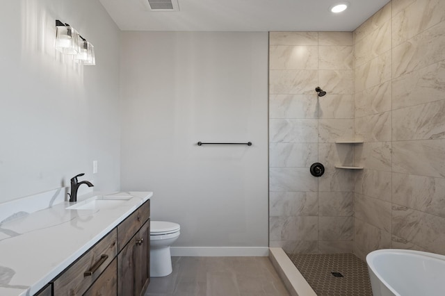 full bathroom featuring vanity, shower with separate bathtub, and toilet