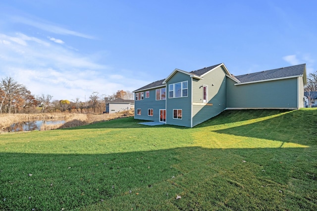 rear view of property featuring a yard and a water view