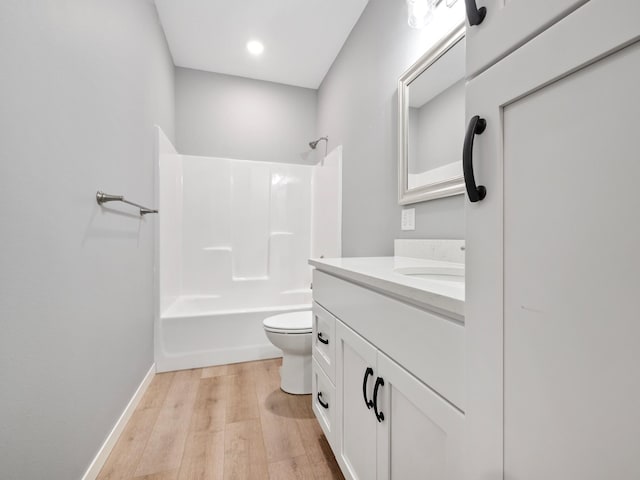 full bathroom featuring  shower combination, wood-type flooring, toilet, and vanity