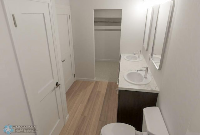 bathroom featuring vanity, toilet, and hardwood / wood-style flooring