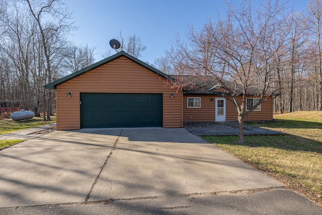 view of front of property with a garage and a front lawn