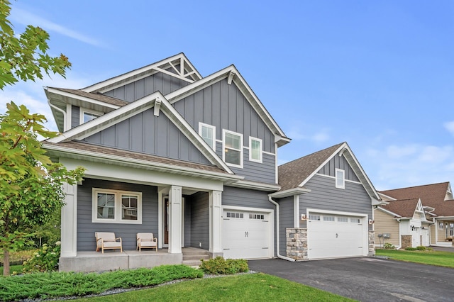 craftsman inspired home with a porch and a garage